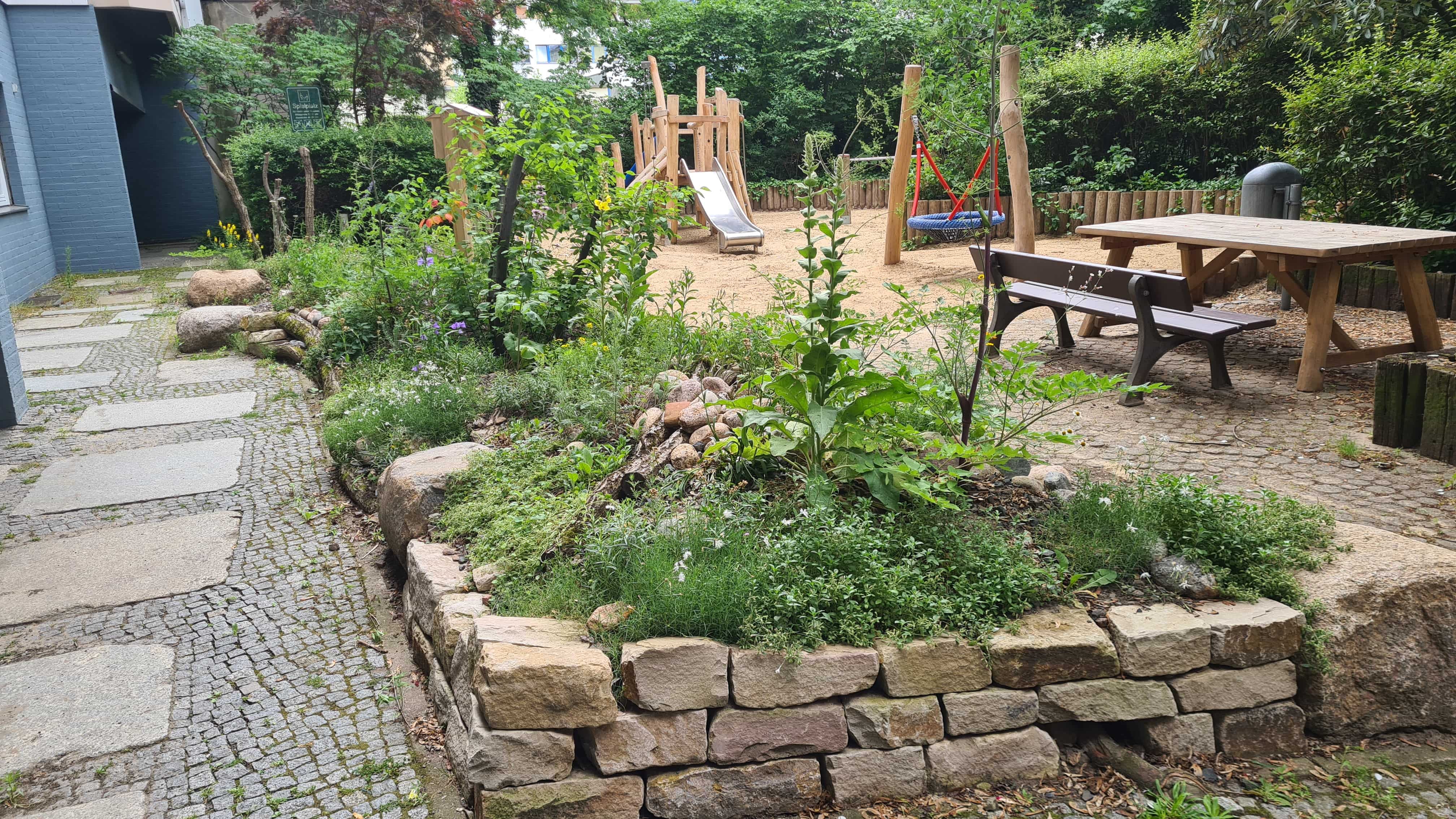 Stadtnatur: Naturnah gestalteter Innenhof mit Spielplatz
